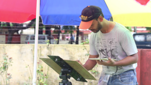 Painting under multicolored umbrella